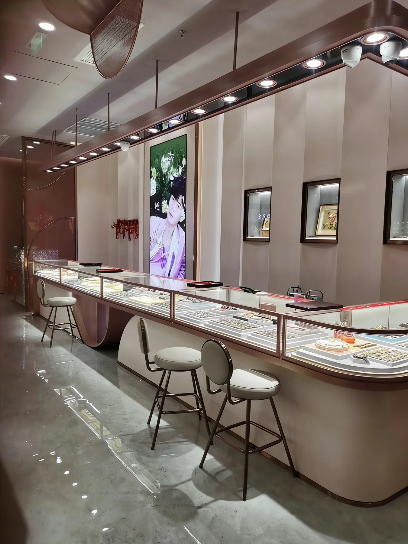 Curved stainless steel jewelry counter in a retail store