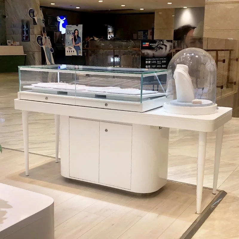 White jewelry counter and round glass dome display